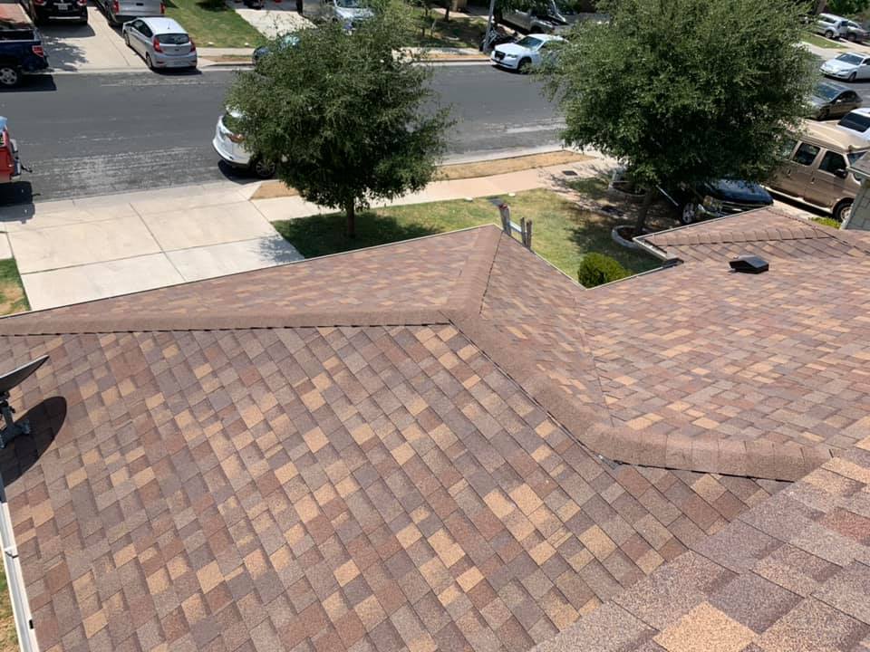 Gutters, siding, and remodeling example: Completed brown shingle roofing project by Friendly Restoration Services in Central Texas